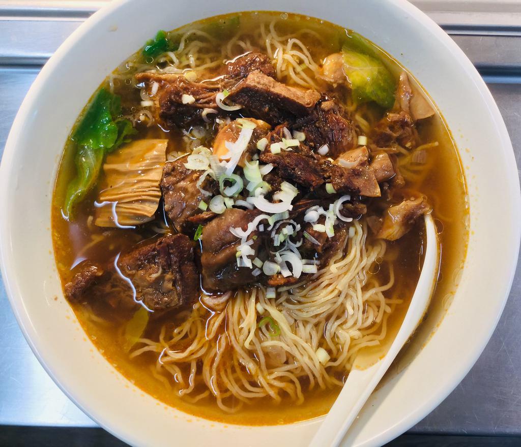 Braised Beef Brisket Noodle Soup · Egg noodles in a clear broth soup with lettuce, green onion, and Hong Kong style braised beef brisket. 
