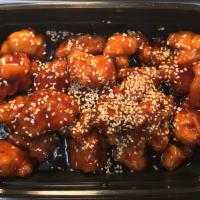 Sesame Chicken · Crispy chicken in sesame sauce, topped with sesame seeds.
