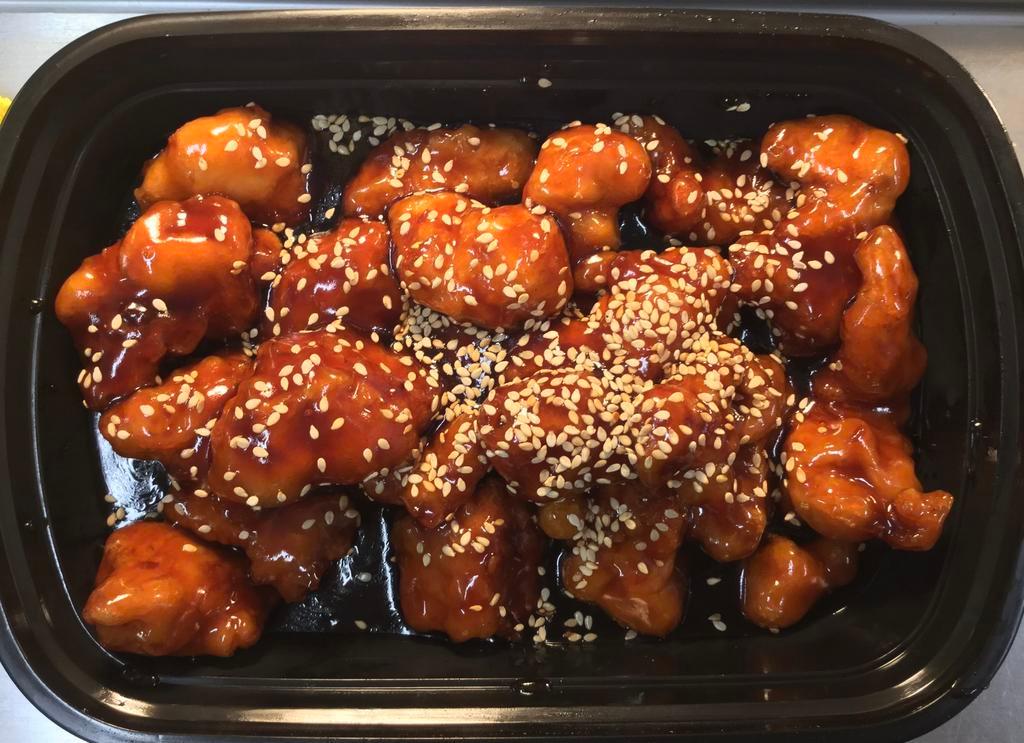 Sesame Chicken · Crispy chicken in sesame sauce, topped with sesame seeds.