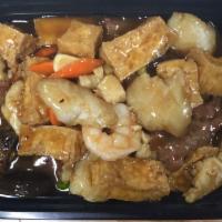 Braised Tofu with Assorted Meat in a Pot · A mix of tofu, beef, shrimp, fish fillet, and carrots in a savory brown sauce. 