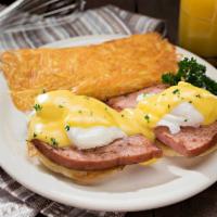 Eggs Benedict · Smoked ham and poached eggs on an English muffin topped with creamy hollandaise sauce and se...