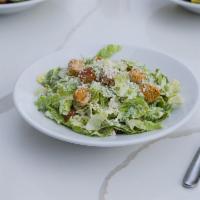 Caesar Salad · Crisp romaine lettuce, Parmesan cheese and toasted croutons tossed with Caesar dressing.