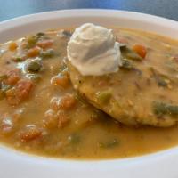 Smothered Pupusa · Choose from one of our Pupusas to be Smothered in Green Chile and Sour Cream