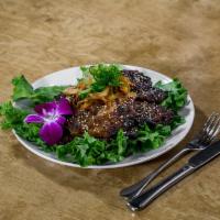 Kimchee Kalbi · Korean style marinated bone-in short ribs grilled to perfection. Served with house-made kimc...