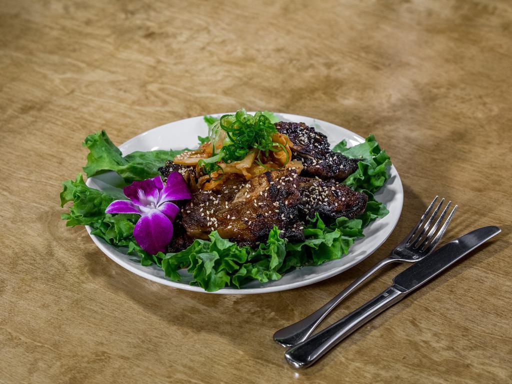 Kimchee Kalbi Meal · Korean style marinated bone-in short ribs grilled to perfection. Served with house-made kimchee, white rice and mix greens.