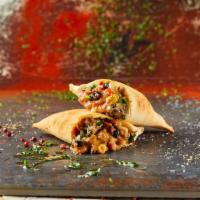 The Cheesy Gaucho Empanada · Our traditional beef empanada with our 3 cheese mix, black beans, kernel corn, crispy bacon ...