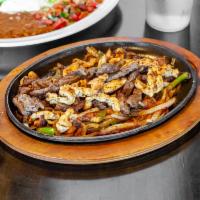 Fajitas · Choice of grilled chicken, steak, or mix. Onions, tomatoes, and bell pepper. Garnished with ...
