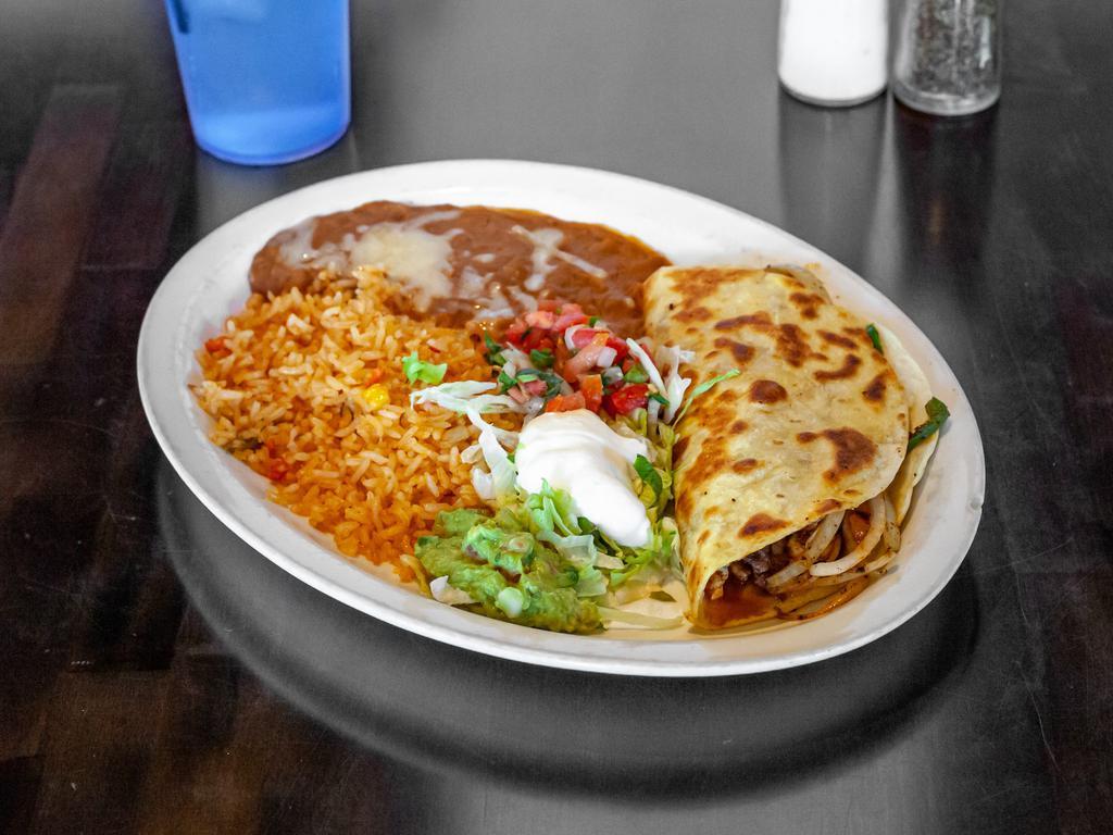 Fajitas Quesadilla Rellena · Steak, grilled chicken or mix. Grilled onion, tomatoes, and bell pepper. Garnished  with lettuce, sour cream, guacamole, pico de Gallo. Served with rice and beans.