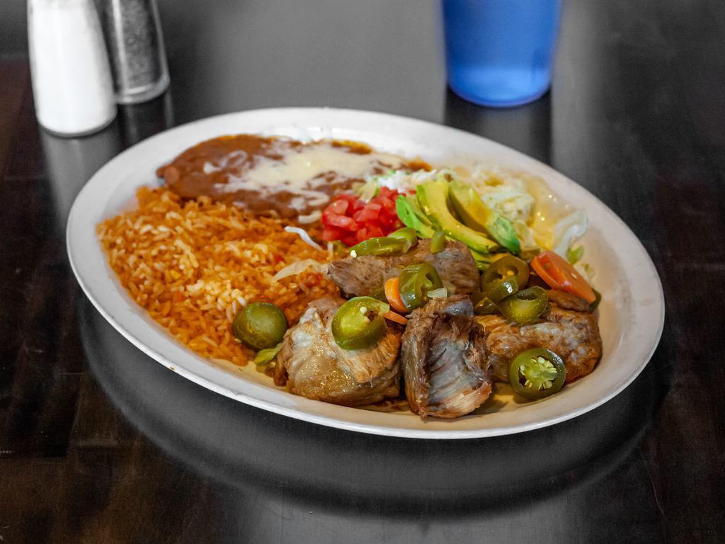 Carnitas · Pork tips carnitas. Garnished with lettuce, avocado, diced tomatoes, and tortillas. Served with rice.