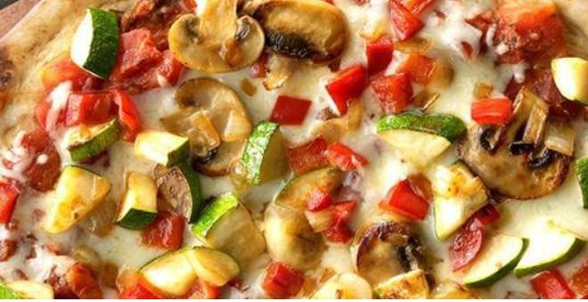 Veggie Flatbread · Mozzarella, green bell peppers, black olives, fresh mushrooms, fresh garlic, red onions and cooked tomatoes.