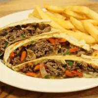 Steak Quesadilla · Grilled Steak with peppers, onions, and cheddar cheese served with sour cream
