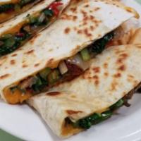 Veggie Quesadilla · Grilled mushrooms, spinach, peppers, onions and cheddar cheese served with sour cream
