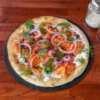 Smoked Salmon Pizza · Cream Fraiche, crispy capers, onions, rainbow radish, fresh dill' black sesame.