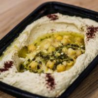 Hummus Salad · Our homemade from scratch creamy hummus served with 1 pita