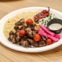 Lamb Tikka Plate · Grilled lamb cubes served over a bed of rice or fresh cut fries + 1 side salad and Tahini sa...