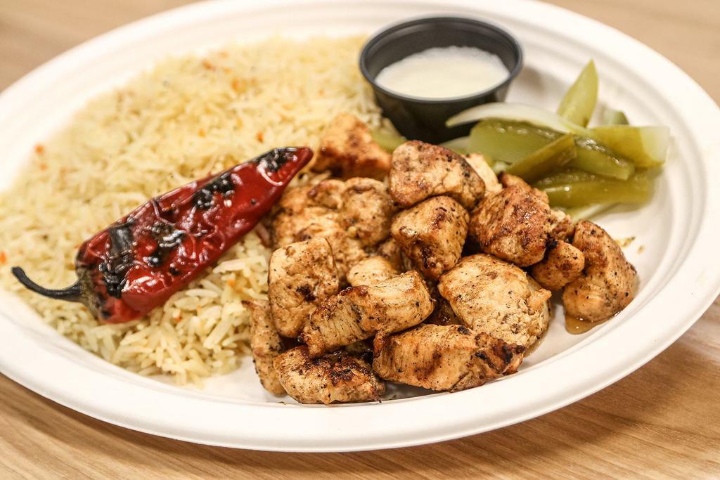Chicken Tawook Plate · Grilled tender chicken cubes marinated in tawook spices served with babel rice or fries + 1 side salad, and garlic olio sauce.