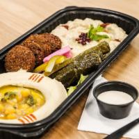 Cold Mezza Platter · A platter to share.
Hummus, Falafel, Baba Ghanoush and Stuffed Grape Leaves Platter