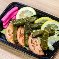 Grape Leaves (4 Count) · Grape leaves stuffed with seasoned rice and cooked in lemon sauce, served cold with pickles ...