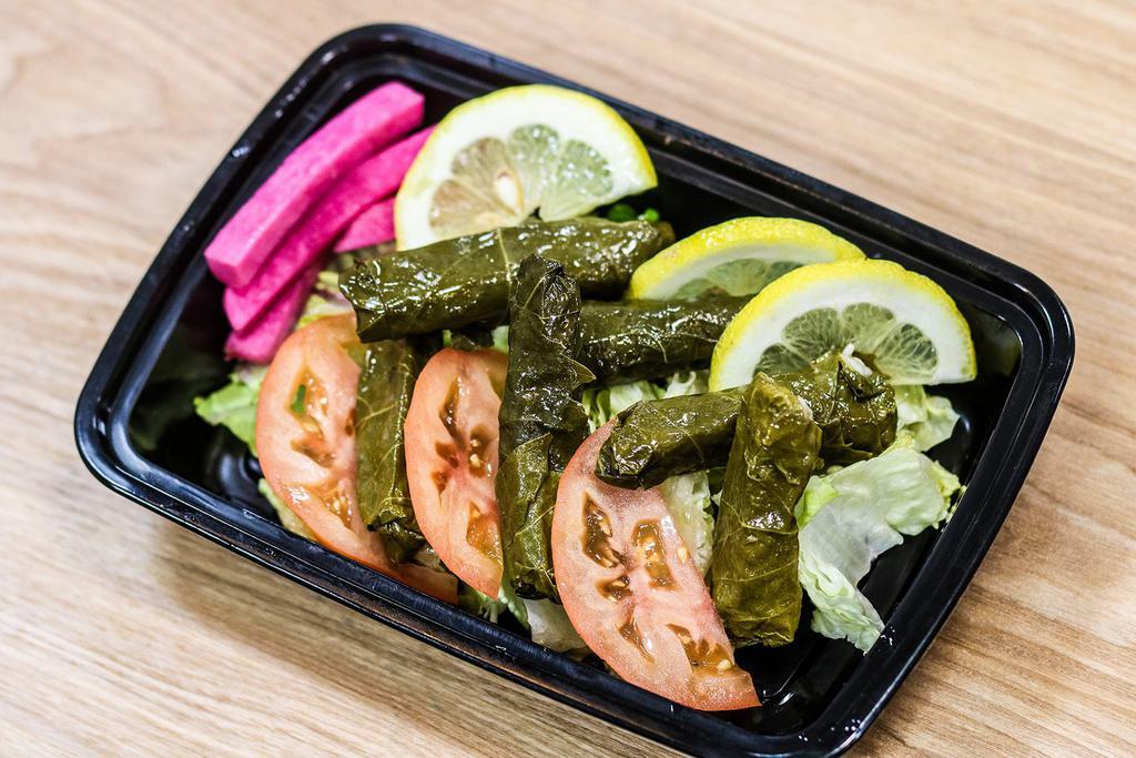 Grape Leaves (4 Count) · Grape leaves stuffed with seasoned rice and cooked in lemon sauce, served cold with pickles and bed of lettuce
