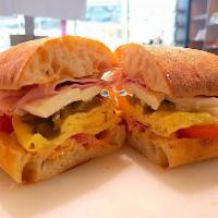 The Hangover Cure · Eggs, ham, tomato, mozzarella, pickled jalapenos and spicy mayo.