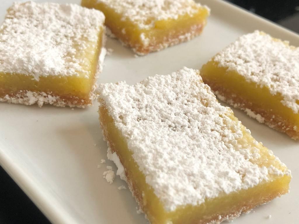 Lemon Bar · A sweet and tart lemony combination!  Shortbread crust base, lemon filling with fresh lemon zest, topped off with powdered sugar.