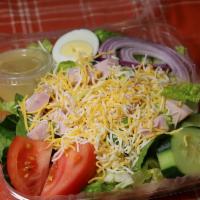The Chef Salad · Hard boiled eggs, crisp lettuce, ham, turkey, cheese, tomatoes, red onions and Italian dress...