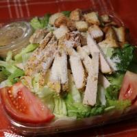 Chicken Caesar Salad · Crisp lettuce, tomatoes, Parmesan and romano cheese, seasoned croutons and Caesar dressing.