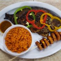 1. Tilapia Fish · Grilled tilapia served with a side of rice and plantain.