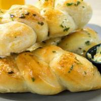 Saucy Bread · House breadsticks with rosemary garlic butter. Vegetarian.