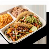 Taco Dinner  · Two Tacos with your choice of meat with onions and cilantro and a side of rice and beans.