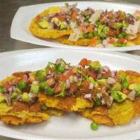 Tostones Chalacos · Crispy tostones topped with fresh onions, tomatoes, fresh lime, avocado, and the port of Cal...
