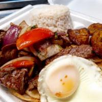 Lomo Saltado a lo Pobre · Tenderloin cubes flambeed with red onion, tomatoes, and cilantro to create. Dishes of Peru a...