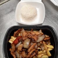 Saltado de pollo · Chicken flambeed with red onion, tomatoes, and cilantro to create. Dishes of Peru accompanie...