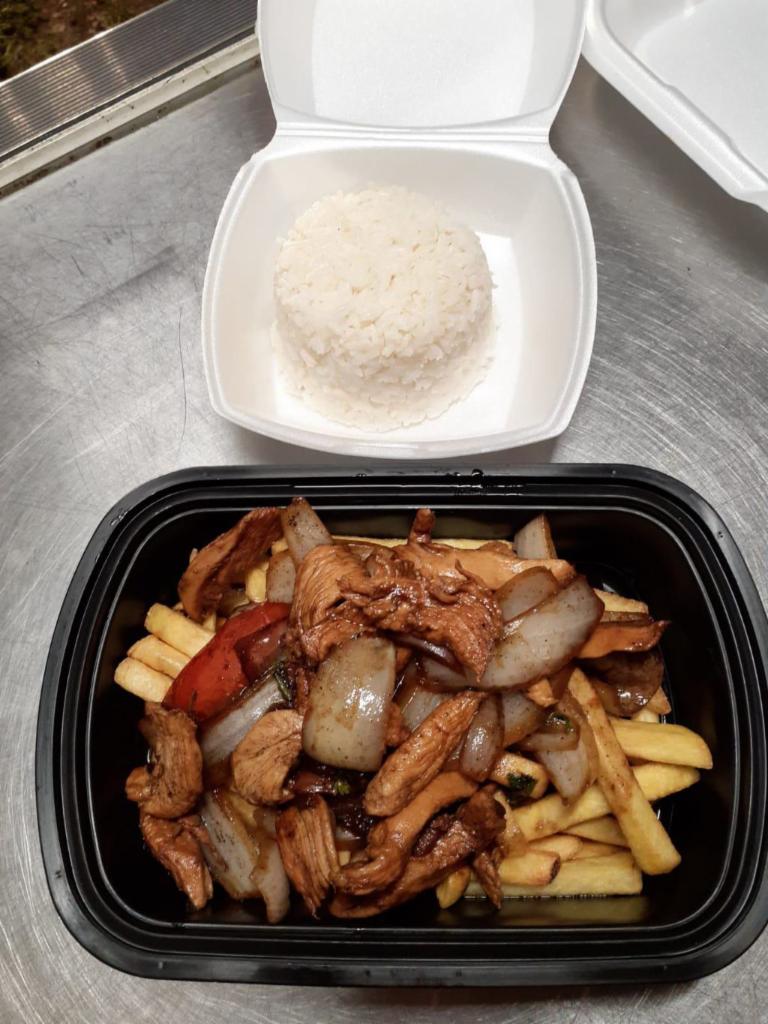 Saltado de pollo · Chicken flambeed with red onion, tomatoes, and cilantro to create. Dishes of Peru accompanied by crispy French fries and white rice.
