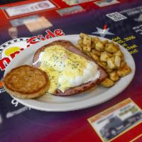Eggs Benedict Breakfast · 2 poached eggs with grilled ham on English muffin topped with hollandaise sauce. Served with...