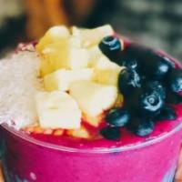Tropic Majik Smoothie Bowl · Bottom: pitaya blended with homemade almond milk, pineapple, and mango. Top: pineapple blend...
