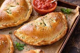 Calzone · Turnover made with ricotta cheese, mozzarella cheese, and choice of spinach or ham.
