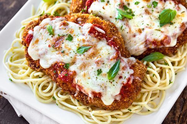 Chicken Parmigiana Pasta · Breaded chicken breast drizzled with our homemade tomato sauce and mozzarella cheese, served with spaghetti and garlic bread.