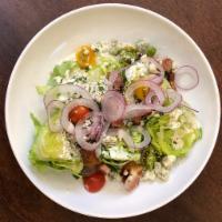 Wedge Salad · Baby Iceberg Lettuce, Bacon, Tomato, Red Onion and Blue Cheese Dressing.