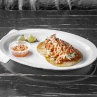 Fish Taco/Taco de Pescado · Lightly beer battered fish on a yellow corn tortilla garnished with cabbage and our house ch...