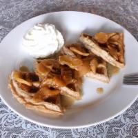 Apple Cinnamon Waffles · Cinnamon waffle topped with cooked apples and our homemade cinnamon syrup.