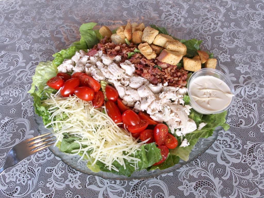 B.L.T. Caesar Salad · Includes fresh cut romaine greens topped with shredded chicken, bacon, tomato, Parmesan cheese and croutons. Served with homemade Caesar dressing.