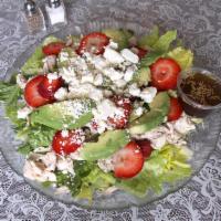 Strawberry Avocado Salad · Fresh strawberries, avocado, chicken and feta cheese on top of fresh cut romaine, served wit...