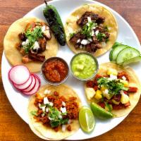 Tacos & Rice · Three Tacos topped with Onion, Cilantro, Salsa, and Your Choice of Protein. Served with Span...