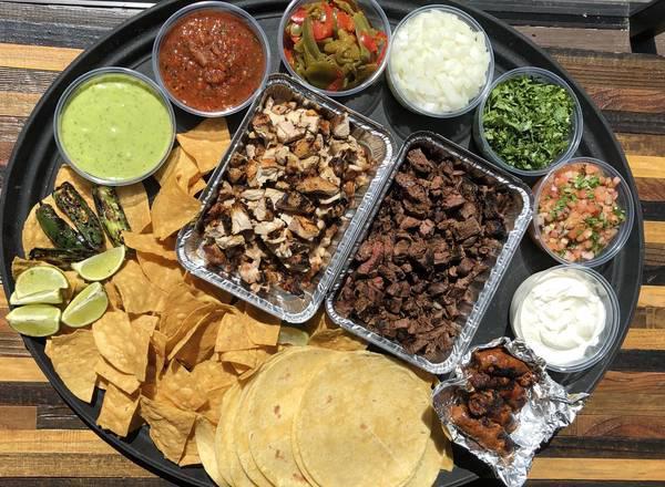 Taco Platter · Serves 3-4. Everything you need to build-your-own Tacos. Includes Flour Tortillas, Grilled Chicken and Steak, Fajita Peppers, Pico de Gallo, Onion, Cilantro, Sour Cream, Lime, Jalapeno, Avocado Sauce, and Roasted Tomato Salsa. Served with Tortilla Chips & a side of Chorizo.