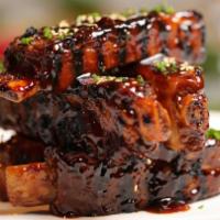Our Ribs · Crispy tender pork ribs smothered in a sweet and spicy sauce.