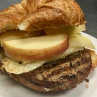 Sausage & Apple Breakfast Sandwich · Egg, sausage, cheddar cheese & apple slices pressed in a croissant.