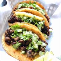 Taco · All tacos are served on warm corn tortillas with choice of cheese, lettuce, and tomato or ci...
