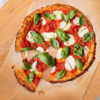 The Crustless Margherita Pie · Crispy cauliflower pizza topped with basil, peppers, extra virgin olive oil and mozzarella c...