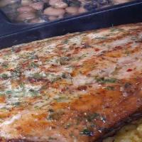 Atlantic Salmon over Yellow Saffron Rice · A generous portion of Atlantic Salmon seasoned with our soulful blend of coastal herbs and s...